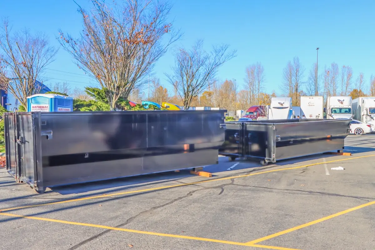 Professional dumpster rental service with roll-off container on residential driveway in East Liverpool